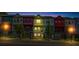 Colorful townhomes bathed in twilight, highlighting their distinctive facades, glowing windows, and inviting ambiance at 2022 Bixby Byway Se Rd, Atlanta, GA 30317