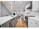 Contemporary eat-in kitchen with stainless steel appliances, hardwood floors, and a stylish island with pendant lighting at 2022 Bixby Byway Se Rd, Atlanta, GA 30317