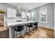 Modern kitchen with a large island, stainless steel appliances, and elegant pendant lighting over the breakfast bar at 2022 Bixby Byway Se Rd, Atlanta, GA 30317