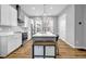 Modern kitchen with stainless steel appliances, white cabinets, and a large island with room for seating at 2022 Bixby Byway Se Rd, Atlanta, GA 30317