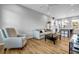 Cozy living room featuring hardwood floors, a plush sofa, and a view into the modern, eat-in kitchen at 2022 Bixby Byway Se Rd, Atlanta, GA 30317