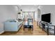 Bright open-concept living room with hardwood floors, comfortable seating, and a modern, eat-in kitchen area at 2022 Bixby Byway Se Rd, Atlanta, GA 30317
