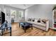 Inviting living room with hardwood floors, comfortable seating, and ample natural light from large windows at 2022 Bixby Byway Se Rd, Atlanta, GA 30317