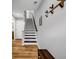 A staircase with sleek design, featuring contrasting wood and white colors and natural light at 2022 Bixby Byway Se Rd, Atlanta, GA 30317