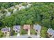 Aerial view of a neighborhood surrounded by lush greenery and mature trees at 457 Skiles Ct, Suwanee, GA 30024