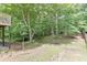 Backyard featuring a wooded lot, mature trees and a small creek at 457 Skiles Ct, Suwanee, GA 30024