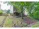 Spacious backyard featuring a deck, stairs, and mature trees providing ample shade at 457 Skiles Ct, Suwanee, GA 30024