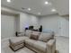 Cozy basement featuring neutral walls, carpet, and a comfortable sectional couch for relaxation and entertainment at 457 Skiles Ct, Suwanee, GA 30024