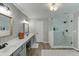 Stylish bathroom features a double sink vanity and a glass-enclosed shower at 457 Skiles Ct, Suwanee, GA 30024
