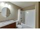 Bathroom featuring granite counters, wood cabinets, tub and shower combo at 457 Skiles Ct, Suwanee, GA 30024