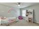 Charming bedroom with colorful decor, rainbow wall art and a desk at 457 Skiles Ct, Suwanee, GA 30024