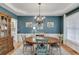 Elegant dining room with classic chandelier, wood table, and neutral rug at 457 Skiles Ct, Suwanee, GA 30024