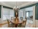 Dining room offers hardwood floors, large windows, and seamless flow into the living area at 457 Skiles Ct, Suwanee, GA 30024