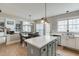 Well-designed kitchen featuring an island with seating, stainless steel appliances, and a view into the living area at 457 Skiles Ct, Suwanee, GA 30024