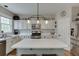 Modern kitchen with white cabinets, stainless steel appliances, an island, and ample countertop space at 457 Skiles Ct, Suwanee, GA 30024