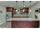 Kitchenette featuring granite counters, custom cabinets, stainless steel fridge and pendant lights at 457 Skiles Ct, Suwanee, GA 30024