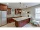 Kitchenette with granite counters, stainless steel refrigerator, and custom cabinets for a sleek design at 457 Skiles Ct, Suwanee, GA 30024