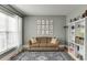 Comfortable living room featuring a sofa, bookshelf and decor at 457 Skiles Ct, Suwanee, GA 30024