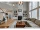 Bright living room featuring a fireplace, built-in shelves, and a large window offering plenty of natural light at 457 Skiles Ct, Suwanee, GA 30024