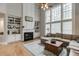 Bright living room with soaring ceilings, fireplace, and built-in shelving at 457 Skiles Ct, Suwanee, GA 30024