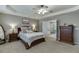 Comfortable main bedroom with a ceiling fan, en-suite, and soft neutral color palette at 457 Skiles Ct, Suwanee, GA 30024