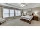Inviting main bedroom with tray ceiling, plush carpeting, and large windows for natural light at 457 Skiles Ct, Suwanee, GA 30024