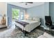 Bedroom with blue walls, a ceiling fan, a large rug, and a door leading to the outside at 5523 Glenridge Ne Park, Atlanta, GA 30342