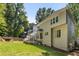 Exterior view of backyard featuring a home with a spacious deck and a lush lawn at 120 Ashewoode Downs Ln, Alpharetta, GA 30005