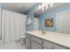 Bright bathroom featuring a vanity with modern fixtures, a well-lit mirror, and a shower with white curtain at 120 Ashewoode Downs Ln, Alpharetta, GA 30005