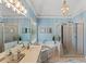 Luxurious bathroom featuring double vanity, soaking tub, and glass-enclosed shower with modern fixtures and decorative accents at 120 Ashewoode Downs Ln, Alpharetta, GA 30005