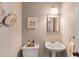 Charming powder room boasting decorative mirror and fixtures, pedestal sink, and tasteful decor at 120 Ashewoode Downs Ln, Alpharetta, GA 30005