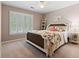 Cozy bedroom with a decorative bed frame, shuttered windows, neutral colored walls, and a ceiling fan at 120 Ashewoode Downs Ln, Alpharetta, GA 30005