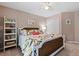 Nicely appointed bedroom featuring a decorative bed frame, floral decor, and neutral colored walls at 120 Ashewoode Downs Ln, Alpharetta, GA 30005