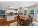 Bright dining area featuring hardwood floors, natural light, and a view into a modern kitchen at 120 Ashewoode Downs Ln, Alpharetta, GA 30005