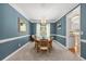 Elegant dining room with a chandelier, large window, and tasteful decor at 120 Ashewoode Downs Ln, Alpharetta, GA 30005
