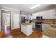 Modern kitchen with white cabinetry, granite countertops, stainless appliances and hardwood floors at 120 Ashewoode Downs Ln, Alpharetta, GA 30005