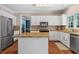 Bright kitchen with stainless steel appliances, granite countertops, and ample cabinet space at 120 Ashewoode Downs Ln, Alpharetta, GA 30005