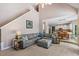 Inviting living room featuring neutral tones, staircase access and a large sectional sofa open to the kitchen area at 120 Ashewoode Downs Ln, Alpharetta, GA 30005