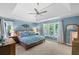 Spacious primary bedroom with tray ceiling, ceiling fan, windows, and ample natural light at 120 Ashewoode Downs Ln, Alpharetta, GA 30005