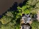 Aerial view of the home showcasing the back deck, lush greenery, water view, and well-maintained surroundings at 2030 Darien Park Dr, Roswell, GA 30076