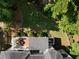 The aerial view shows the backyard deck, landscaping, and the home's proximity to lush trees and lawn at 2030 Darien Park Dr, Roswell, GA 30076