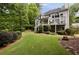 Lush backyard featuring mature trees and a well-maintained lawn, providing a serene outdoor space at 2030 Darien Park Dr, Roswell, GA 30076