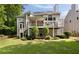 Expansive backyard with a covered patio, multiple decks, and lush greenery for outdoor enjoyment at 2030 Darien Park Dr, Roswell, GA 30076