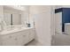 Updated bathroom with a white vanity, tile floors, and a decorative mirror at 2030 Darien Park Dr, Roswell, GA 30076