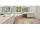 Bright bathroom features double vanity sinks, soaker tub, and window with shutters at 2030 Darien Park Dr, Roswell, GA 30076