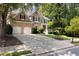 Traditional brick home boasting a manicured front yard, a spacious driveway, and a welcoming two-car garage at 2030 Darien Park Dr, Roswell, GA 30076