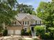 Stately brick home featuring a well-maintained lawn and landscaping, complete with a two-car garage at 2030 Darien Park Dr, Roswell, GA 30076
