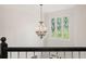 Bright foyer features a beautiful chandelier and diamond-pane windows overlooking green trees at 2030 Darien Park Dr, Roswell, GA 30076