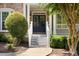 Inviting front entrance with black double doors, white columns, and meticulously maintained landscaping at 2030 Darien Park Dr, Roswell, GA 30076