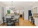 Eat-in kitchen with wood floors, white cabinets, granite counters, and stainless steel appliances at 2030 Darien Park Dr, Roswell, GA 30076